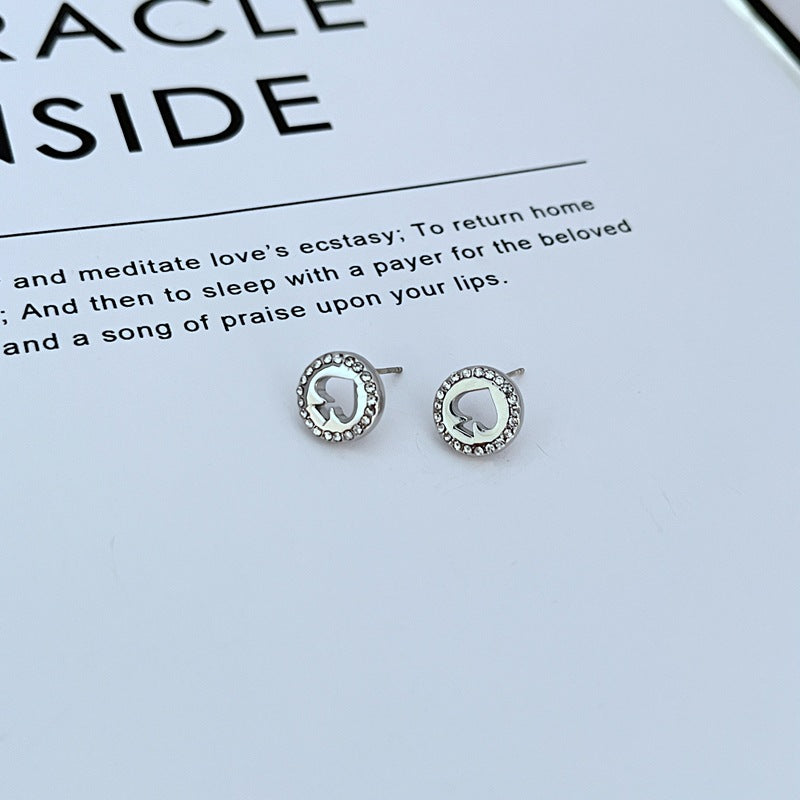  Earrings on a clean white or soft grey background, showcasing the crystal-pavé spade shape. Alt: “Kate Spade Spot The Spade Gold Tone Crystal Stud Earrings – Pavé Spade Jewelry.”
