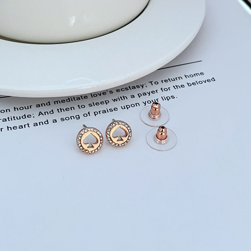  Earrings on a clean white or soft grey background, showcasing the crystal-pavé spade shape. Alt: “Kate Spade Spot The Spade Gold Tone Crystal Stud Earrings – Pavé Spade Jewelry.”