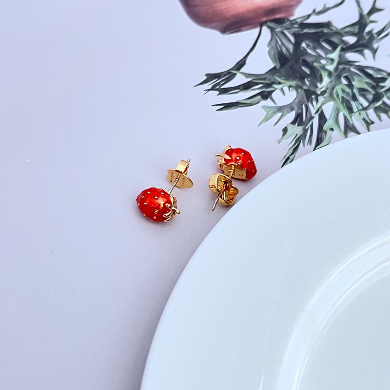 Earrings styled alongside fresh strawberries, a picnic basket, or a sunny window sill. Alt: “Berry Fresh: Styling the Kate Spade Strawberry Fields Stud Earrings.”