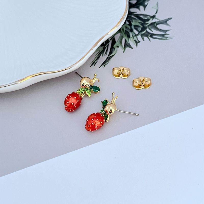  Earrings on soft pink or garden green background. Alt: “Kate Spade Strawberry Fleur Drop Earrings – Enamel Fruit Floral Jewelry.”