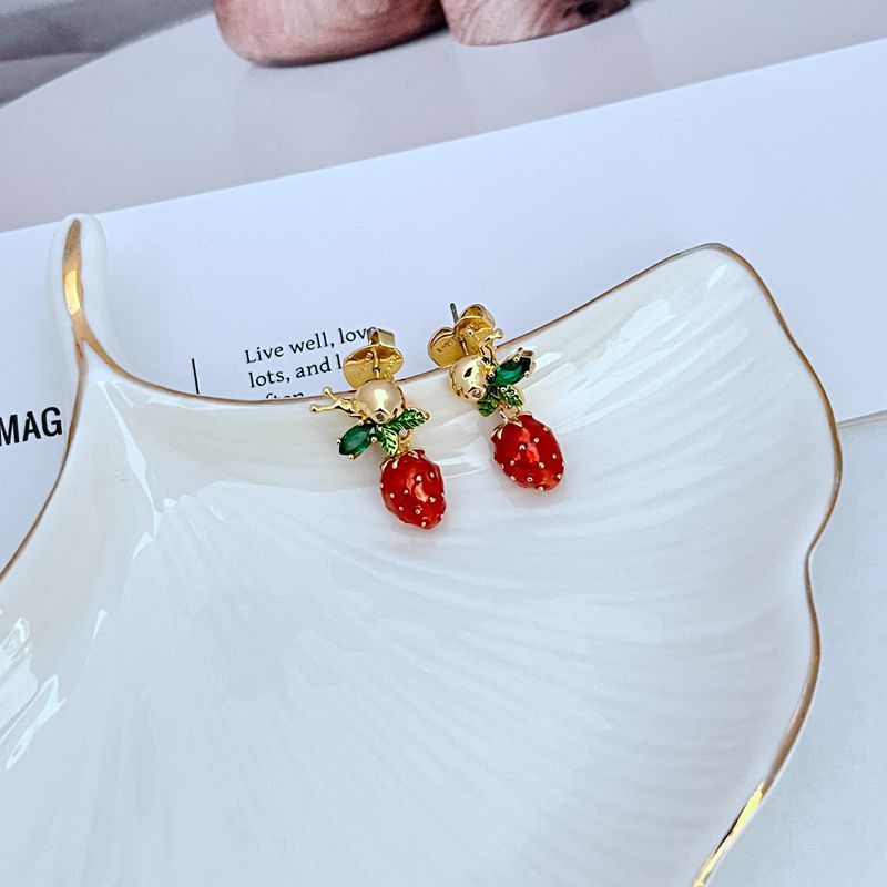  Earrings on soft pink or garden green background. Alt: “Kate Spade Strawberry Fleur Drop Earrings – Enamel Fruit Floral Jewelry.”