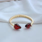 Bracelet on a light, natural background (white wood or pale pink), highlighting the strawberry enamel details. Alt: “Kate Spade Strawberry Gold Bracelet – Dainty Fruit Charm Jewelry.”