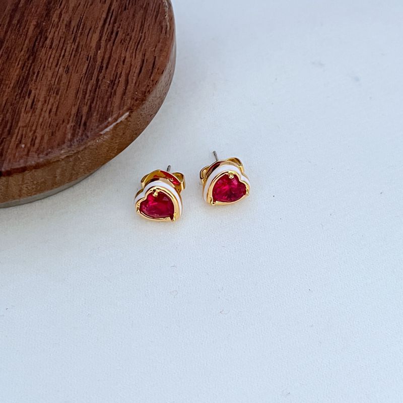 Clean shot of the bracelet laid flat or slightly curved, on a neutral background, clearly showing the line of heart charms.