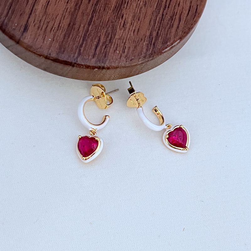 Clean shot of the bracelet laid flat or slightly curved, on a neutral background, clearly showing the line of heart charms.