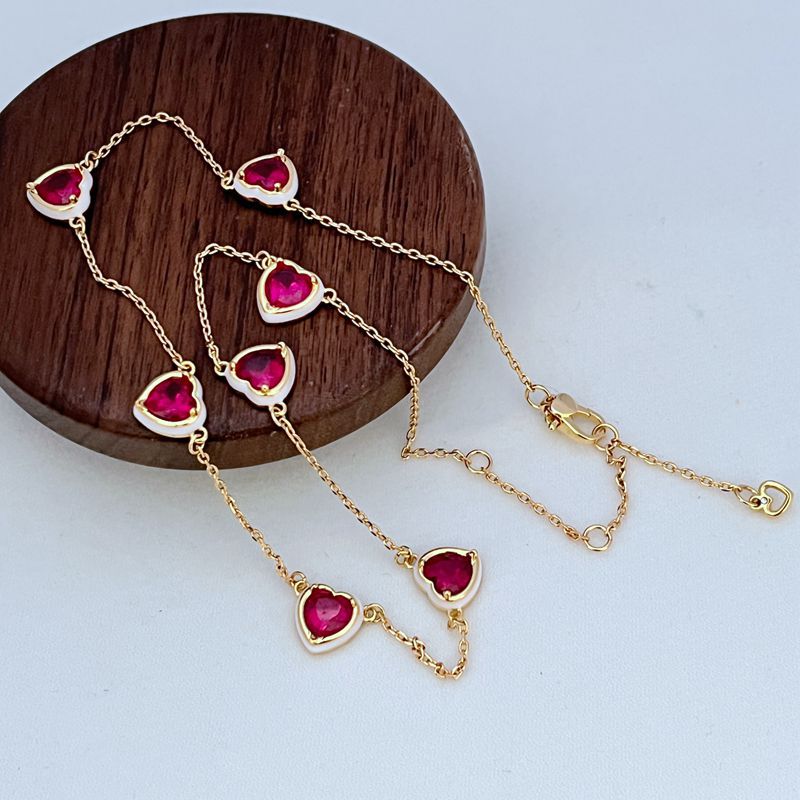 Clean shot of the bracelet laid flat or slightly curved, on a neutral background, clearly showing the line of heart charms.