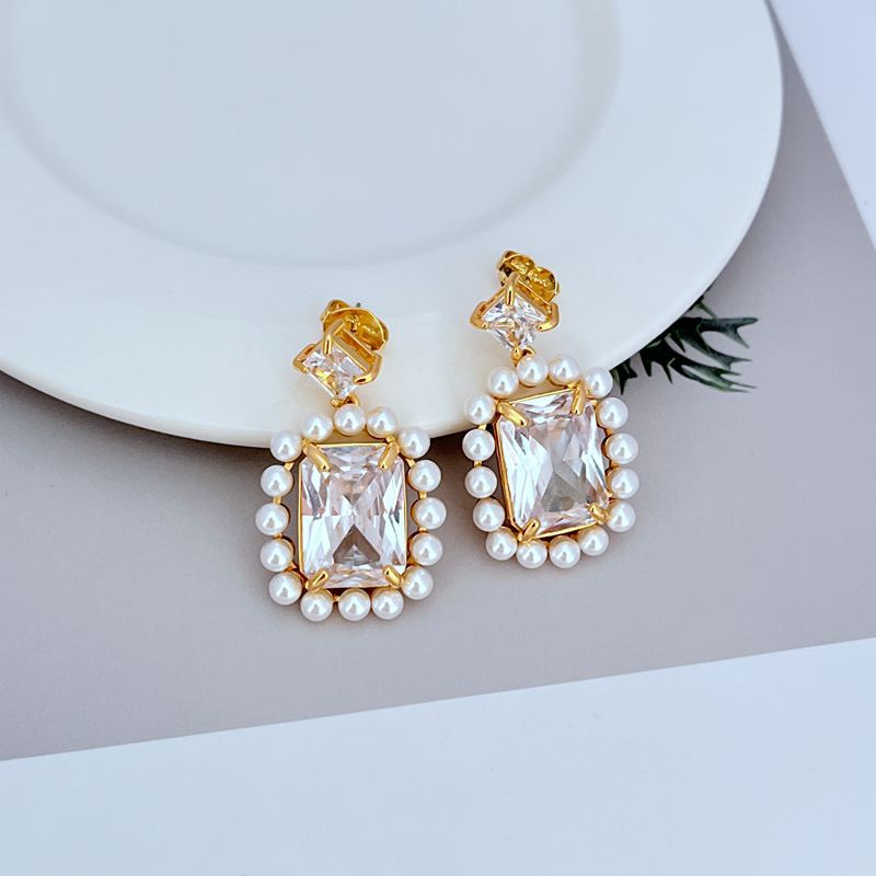 Earrings on soft blush or cream background. Alt: “Kate Spade Victoria Drop Earrings – Crystal & Pearl Dangle Jewelry.”