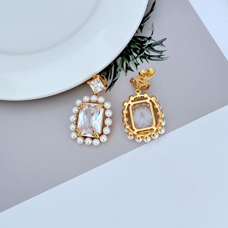 Earrings on soft blush or cream background. Alt: “Kate Spade Victoria Drop Earrings – Crystal & Pearl Dangle Jewelry.”