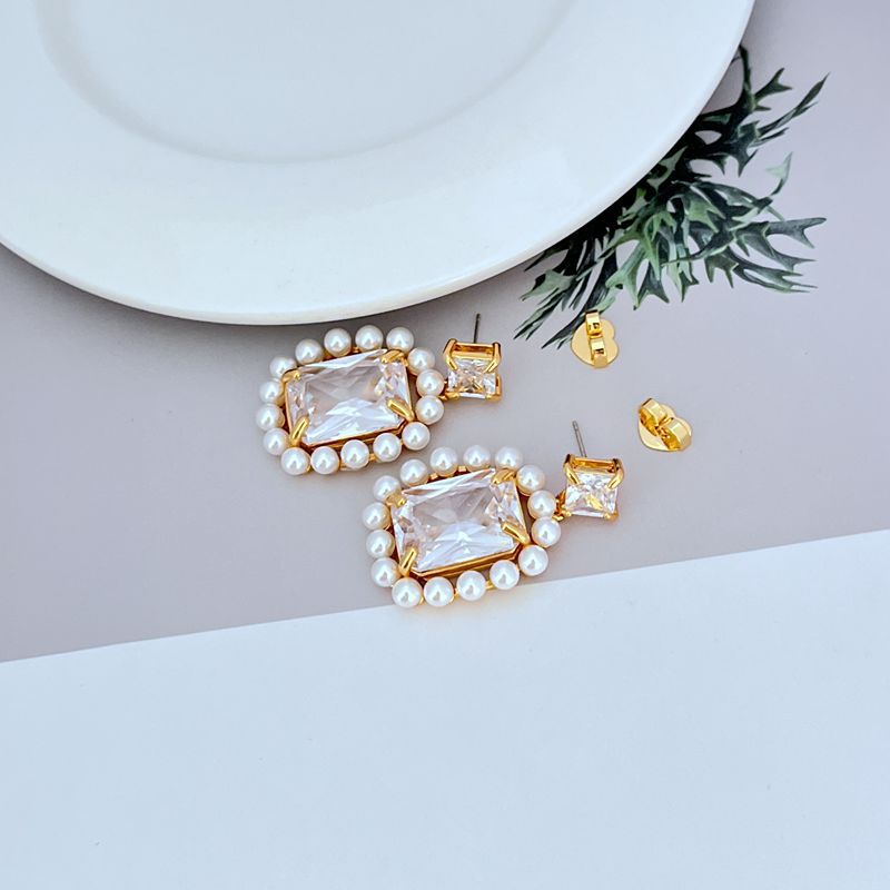 Earrings on soft blush or cream background. Alt: “Kate Spade Victoria Drop Earrings – Crystal & Pearl Dangle Jewelry.”