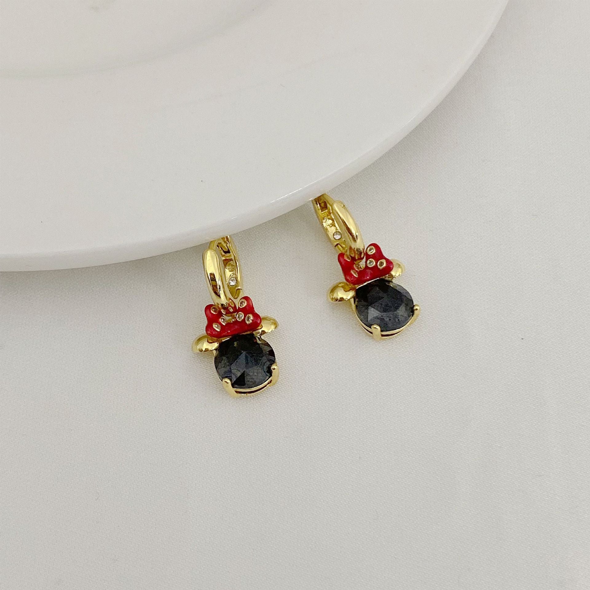 High-definition shot of the pair of earrings laid flat on pure white background, arranged symmetrically.