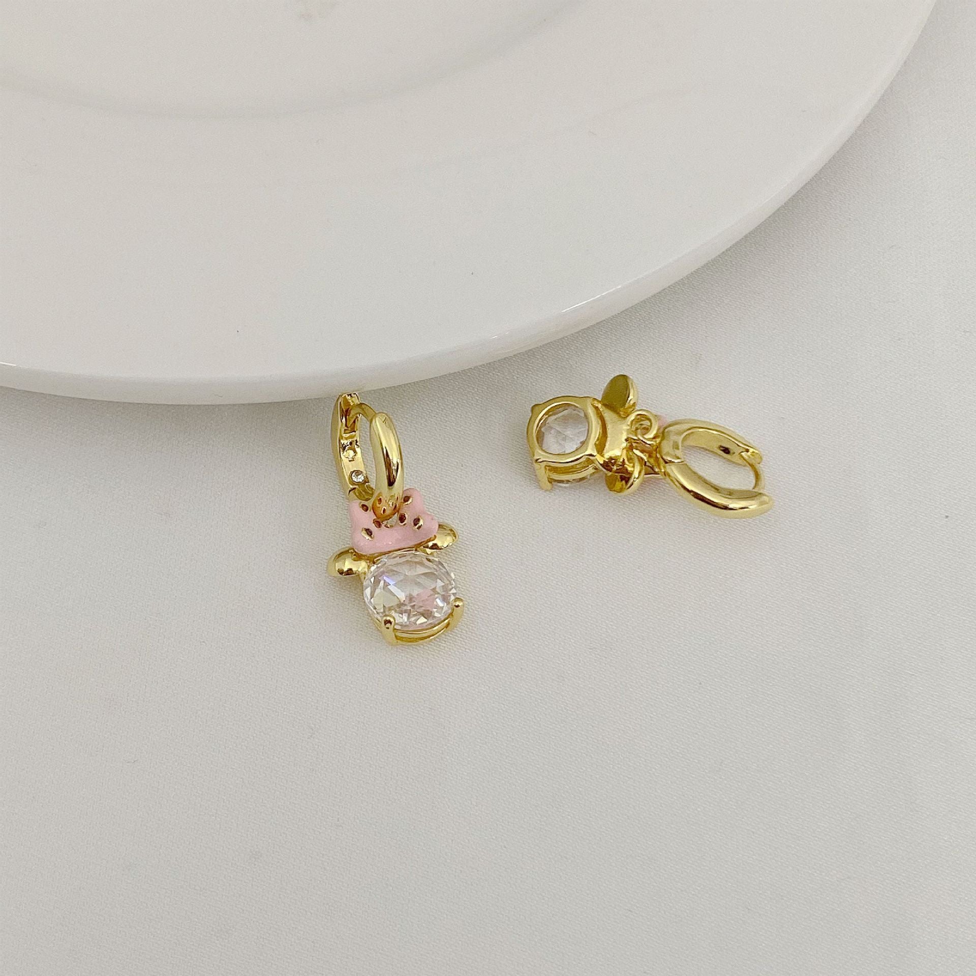 High-definition shot of the pair of earrings laid flat on pure white background, arranged symmetrically.