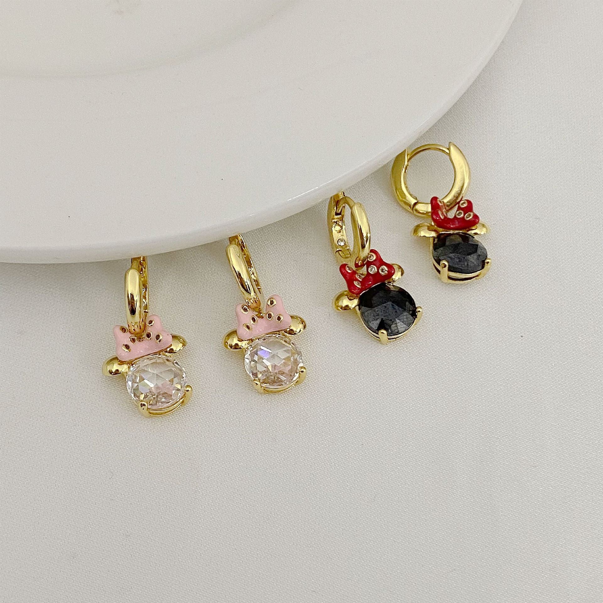 High-definition shot of the pair of earrings laid flat on pure white background, arranged symmetrically.