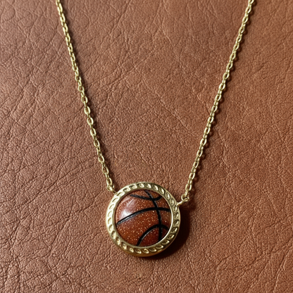Necklace with a basketball pendant on a brown leather background