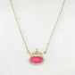 Clean shot of the necklace on a light background, showcasing the blue crystal's sparkle and the gold setting.