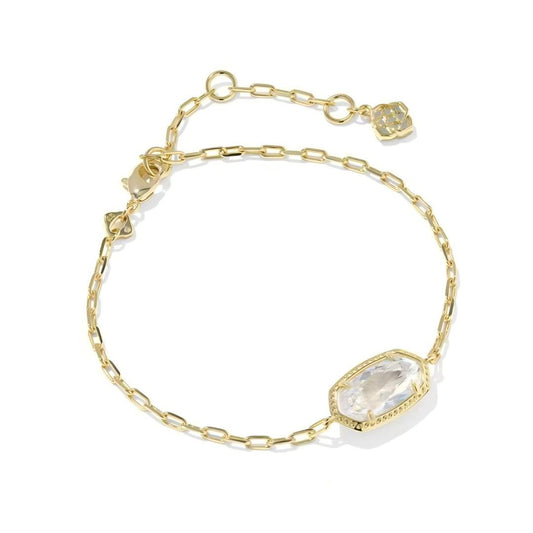 Gold bracelet with a large clear gemstone on a white background