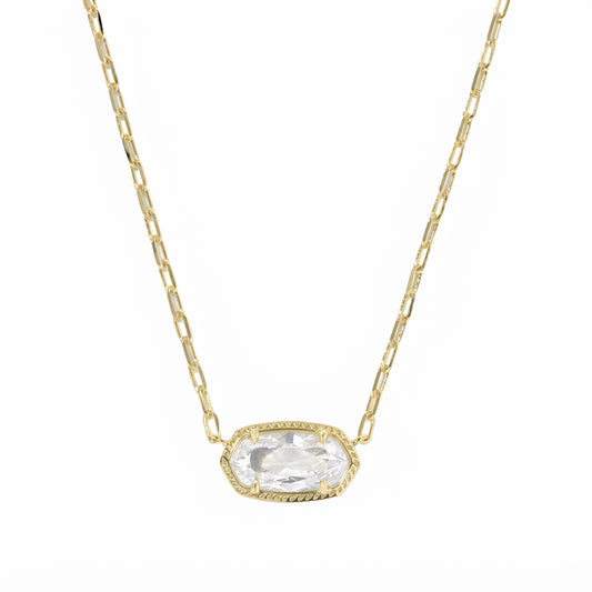 A gold chain necklace with an oval bezel-set clear gemstone pendant, shown against a plain white background.