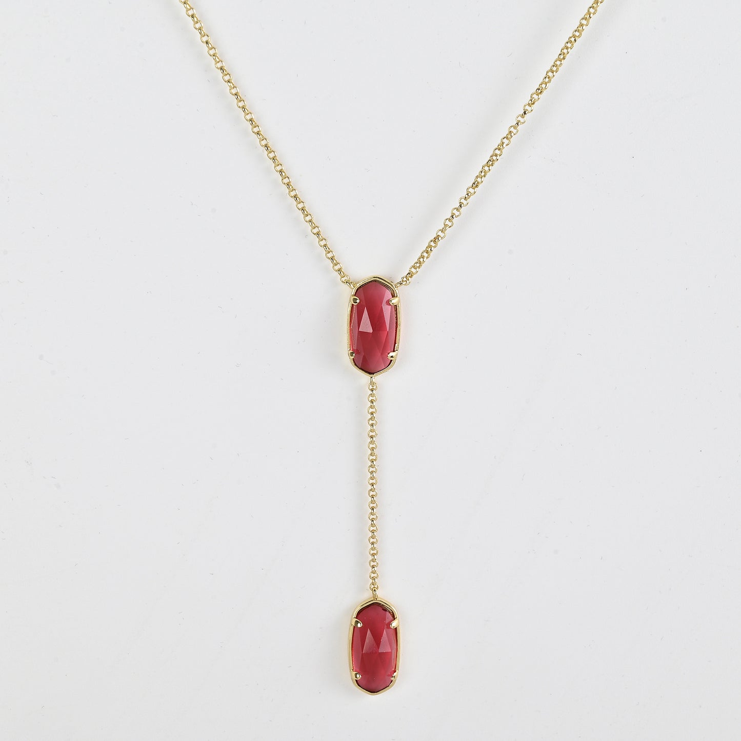 Clean shot of the necklace laid flat to show the Y-shape and pendant detail against a neutral background