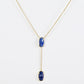 Clean shot of the necklace laid flat to show the Y-shape and pendant detail against a neutral background