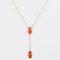 Clean shot of the necklace laid flat to show the Y-shape and pendant detail against a neutral background