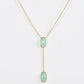 Clean shot of the necklace laid flat to show the Y-shape and pendant detail against a neutral background
