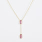Clean shot of the necklace laid flat to show the Y-shape and pendant detail against a neutral background