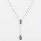 Clean shot of the necklace laid flat to show the Y-shape and pendant detail against a neutral background