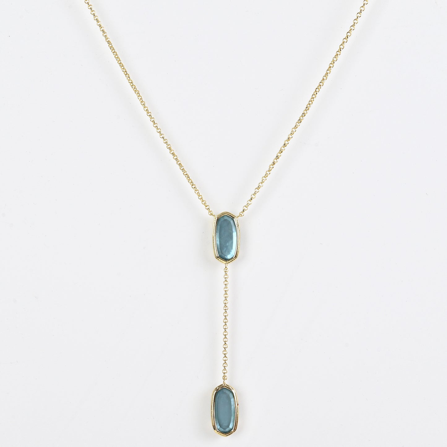 Clean shot of the necklace laid flat to show the Y-shape and pendant detail against a neutral background