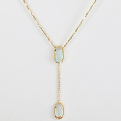 Clean shot of the necklace laid flat to show the Y-shape and pendant detail against a neutral background
