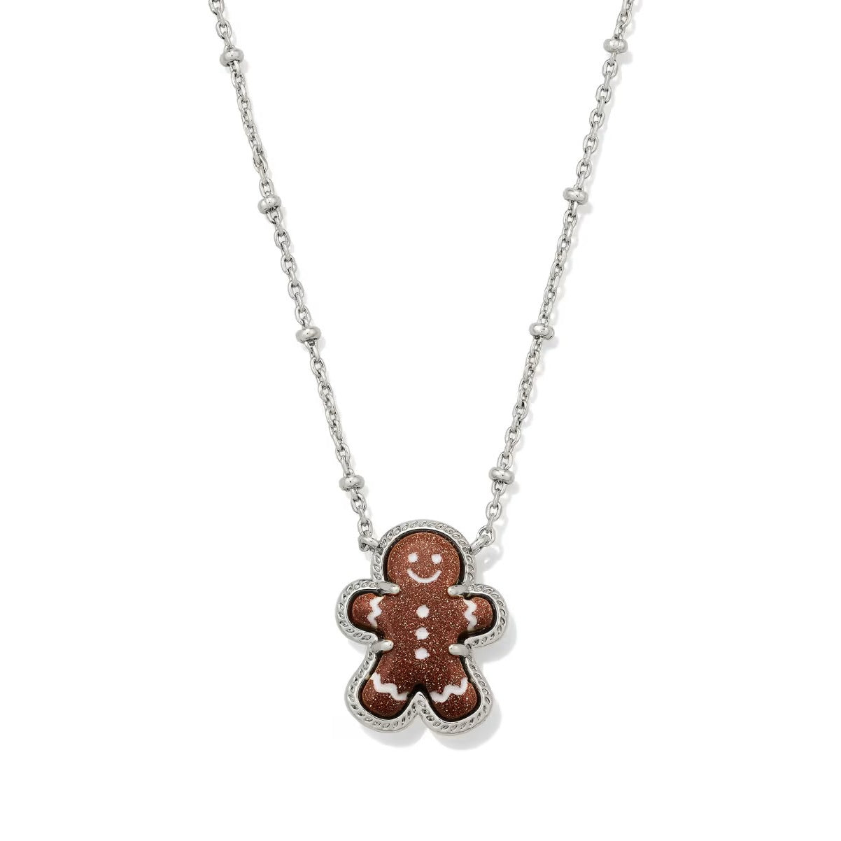 Festive shot of the necklace on a holiday-themed background (like a red velvet or plaid fabric), highlighting the charm.
