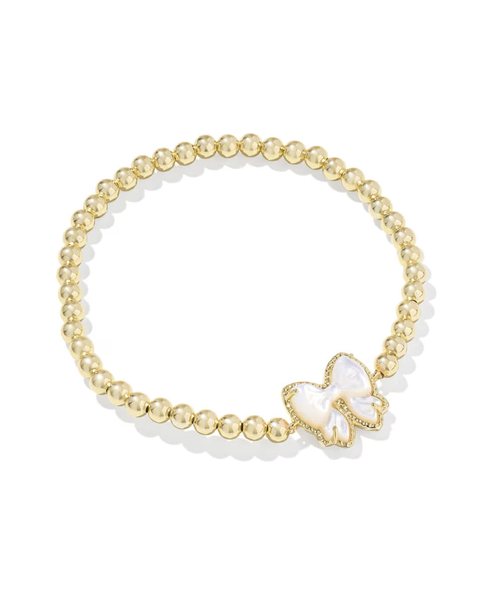  Clean shot of the bracelet laid flat or slightly curved, against a neutral background, clearly showing the bow charm and stretch band.