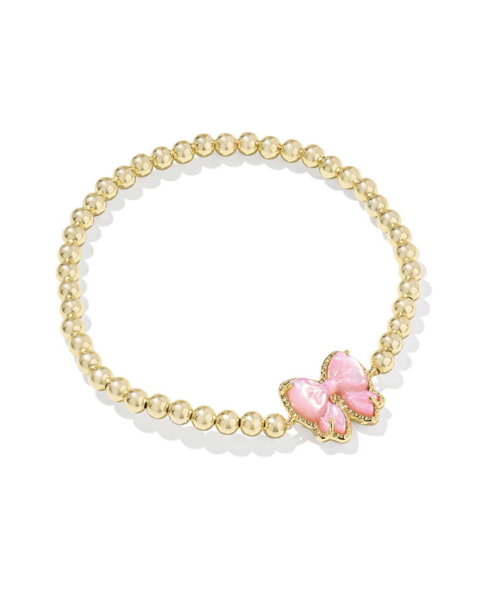  Clean shot of the bracelet laid flat or slightly curved, against a neutral background, clearly showing the bow charm and stretch band.