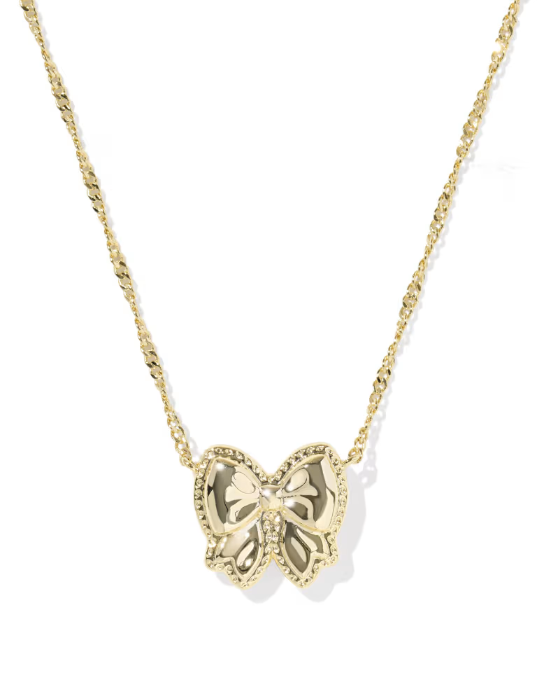 Clean shot of the necklace laid flat or worn, against a light background, clearly showing the bow pendant and short chain length.