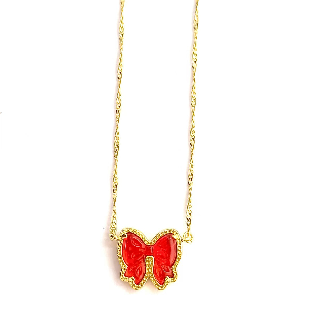 Clean shot of the necklace laid flat or worn, against a light background, clearly showing the bow pendant and short chain length.