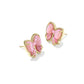 Clean, front-facing shot of a single stud against a soft, neutral background, highlighting the detailed bow shape.