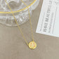ZERRA Kendra Scott volleyball gold short pendant necklace with a delicate chain and a round pendant, stylish jewelry accessory.