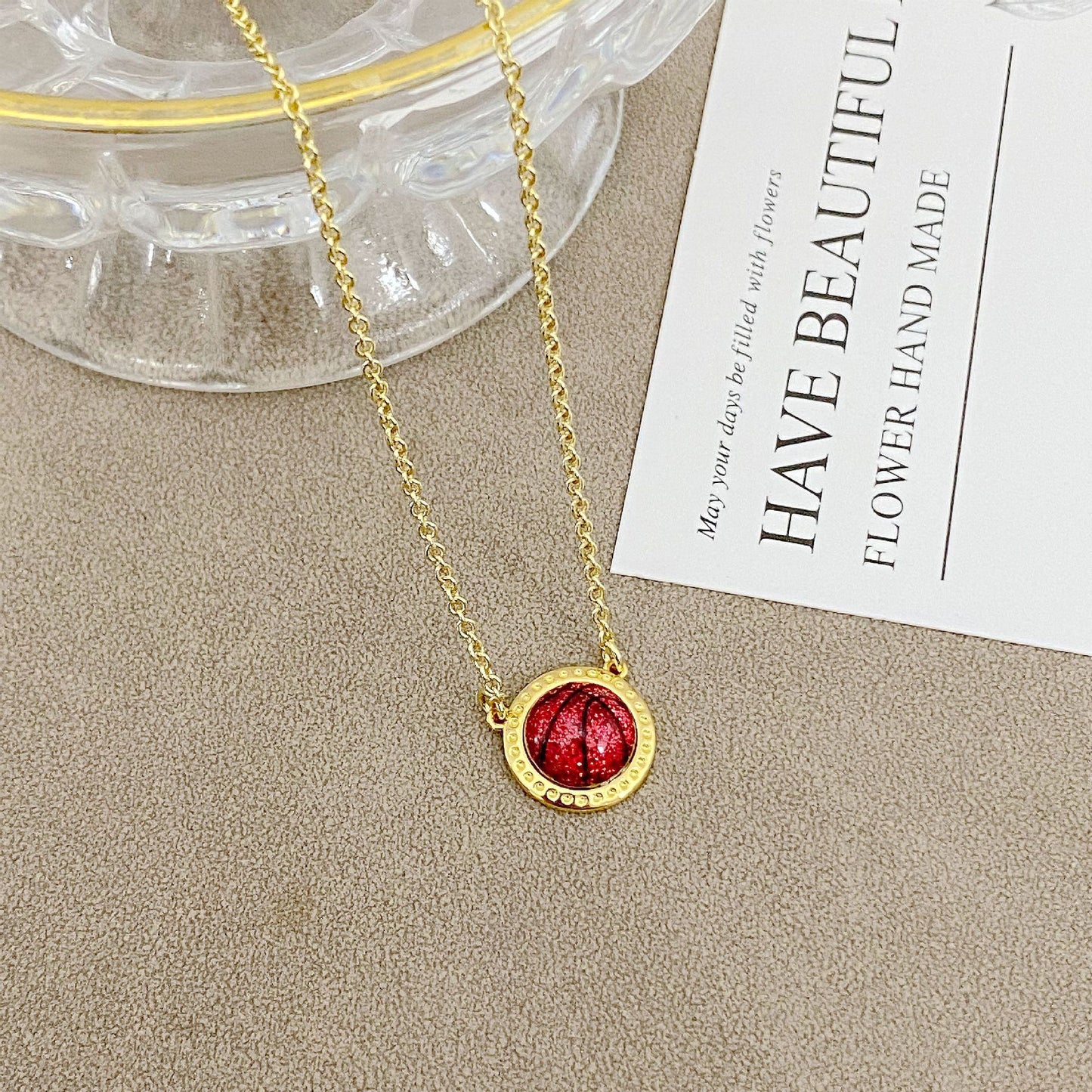 ZERRA Kendra Scott gold short pendant volleyball necklace with delicate chain and small ball pendant, stylish jewelry accessory.