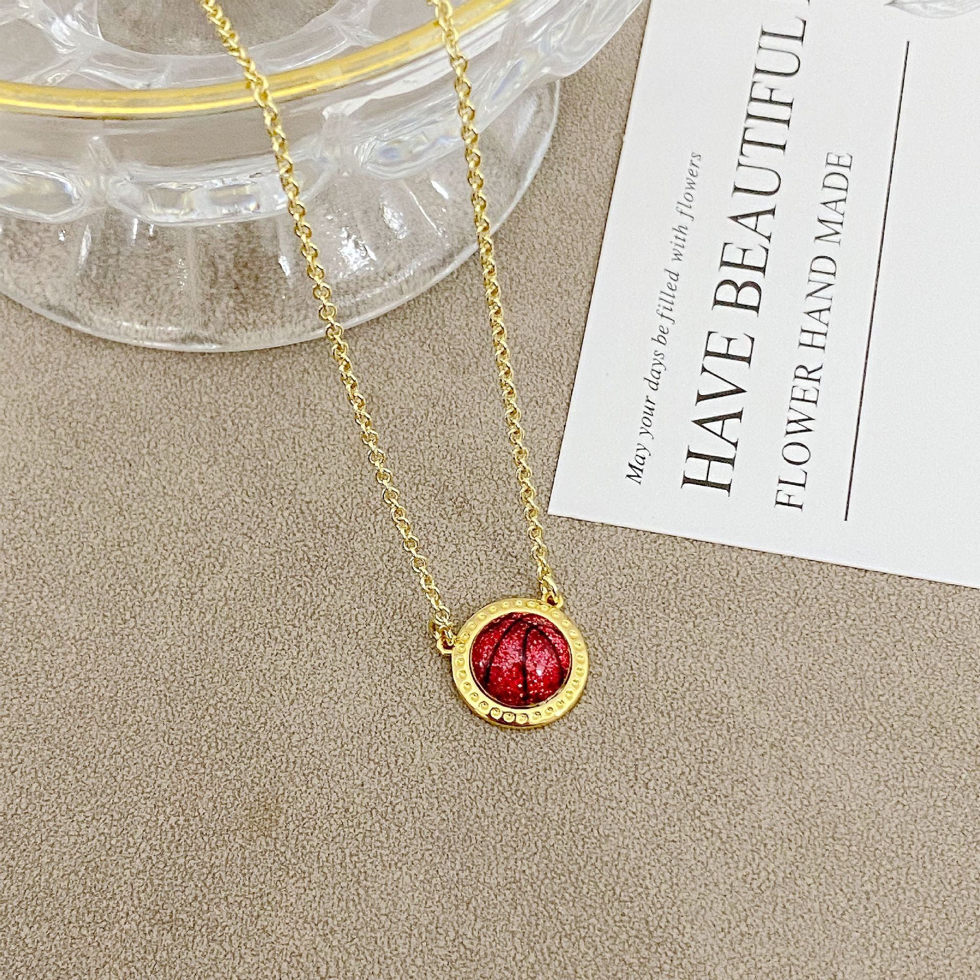 ZERRA Kendra Scott gold short pendant volleyball necklace with delicate chain and small ball pendant, stylish jewelry accessory.