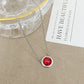 ZERRA Kendra Scott gold volleyball short pendant necklace with delicate chain and small round pendant on a white background.