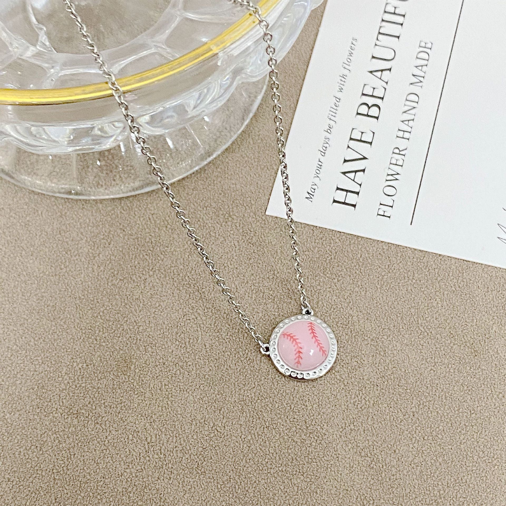 ZERRA Kendra Scott gold short pendant necklace with a volleyball-shaped charm on a delicate chain.