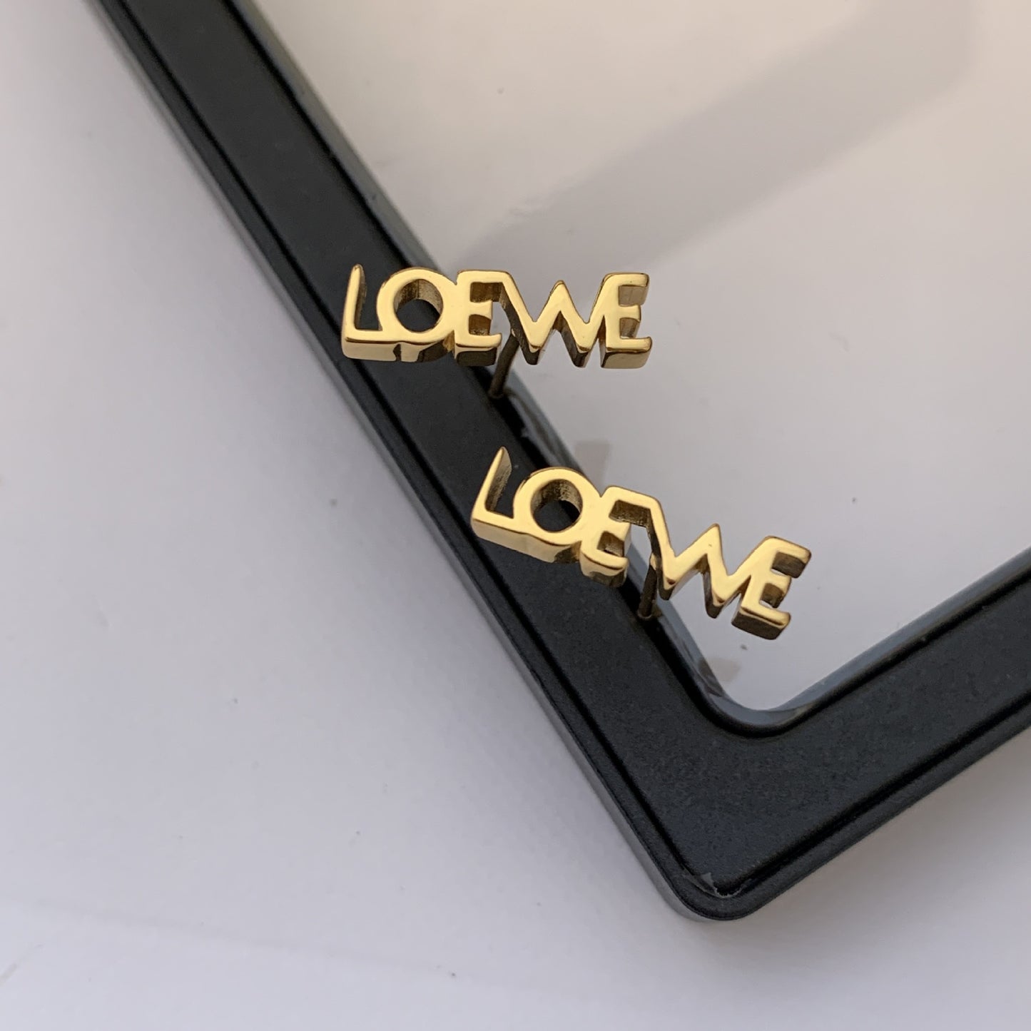  Powerful, focused shot of the single earring against a clean background, emphasizing its graphic design.