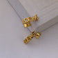  Powerful, focused shot of the single earring against a clean background, emphasizing its graphic design.