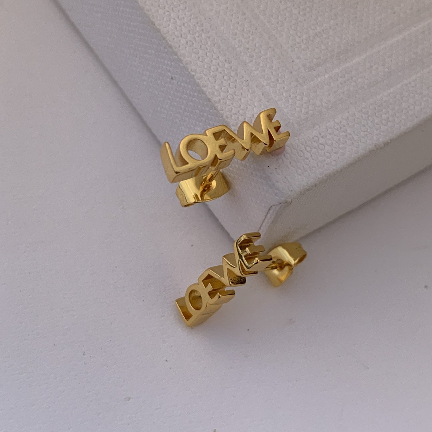  Powerful, focused shot of the single earring against a clean background, emphasizing its graphic design.