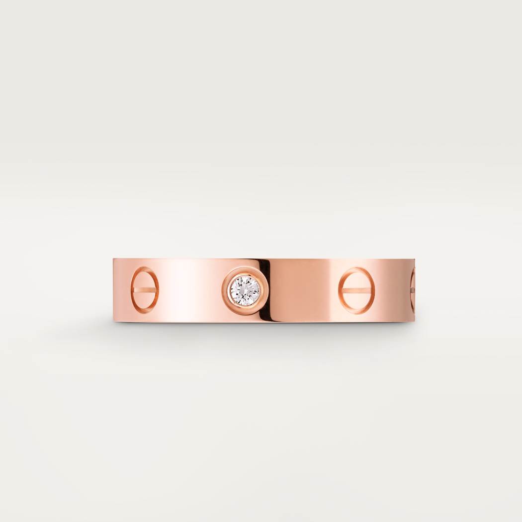Rose gold bracelet with a diamond on a light gray background