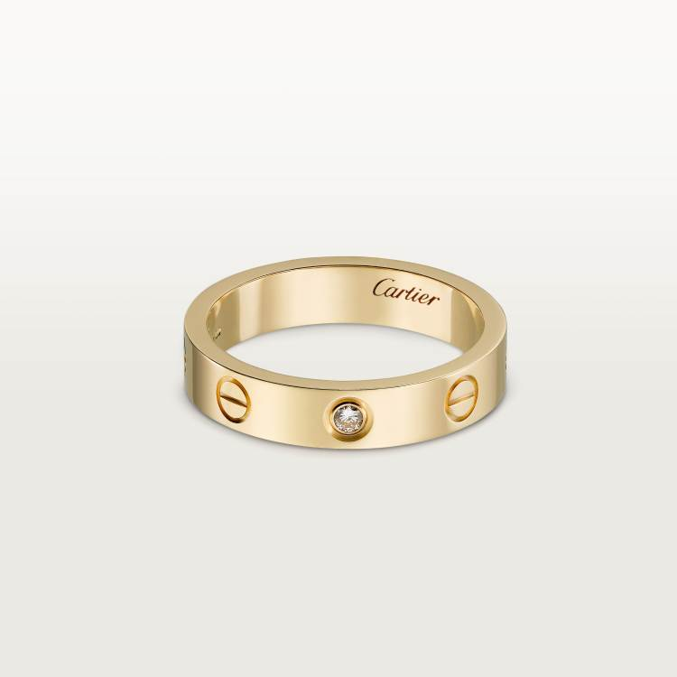 Gold Cartier ring with a diamond on a light gray backgroundLOVE Ring with Single Diamond | 18K Gold-Plated Sterling Silver