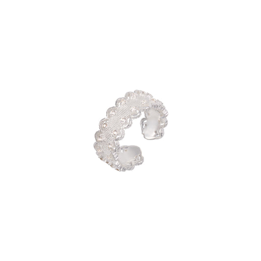 Silver ring with intricate design on a white background