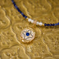 Necklace with blue and white beads on a gold textured background