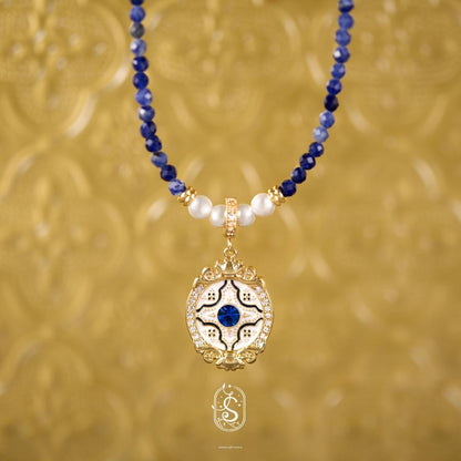 Necklace with blue and white beads and a gold pendant on a gold background