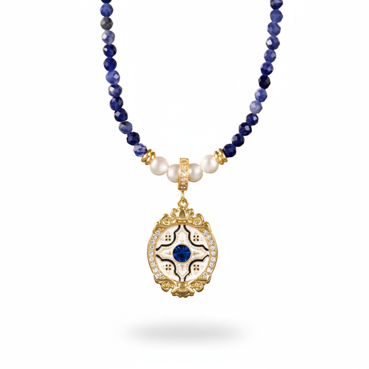 Necklace with blue beads, pearls, and a decorative pendant on a white background