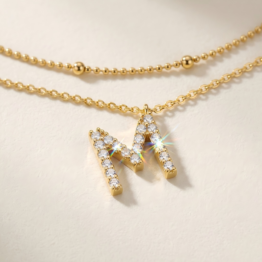 Angle: Straight-on to clearly showcase the two different chain lengths and the letter "M" pendants at their respective positions.