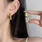 Close-up of the earrings being worn, focusing on how they frame the face with subtle elegance.