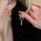 Macro shot focused on the two earrings together, highlighting the contrast in design.